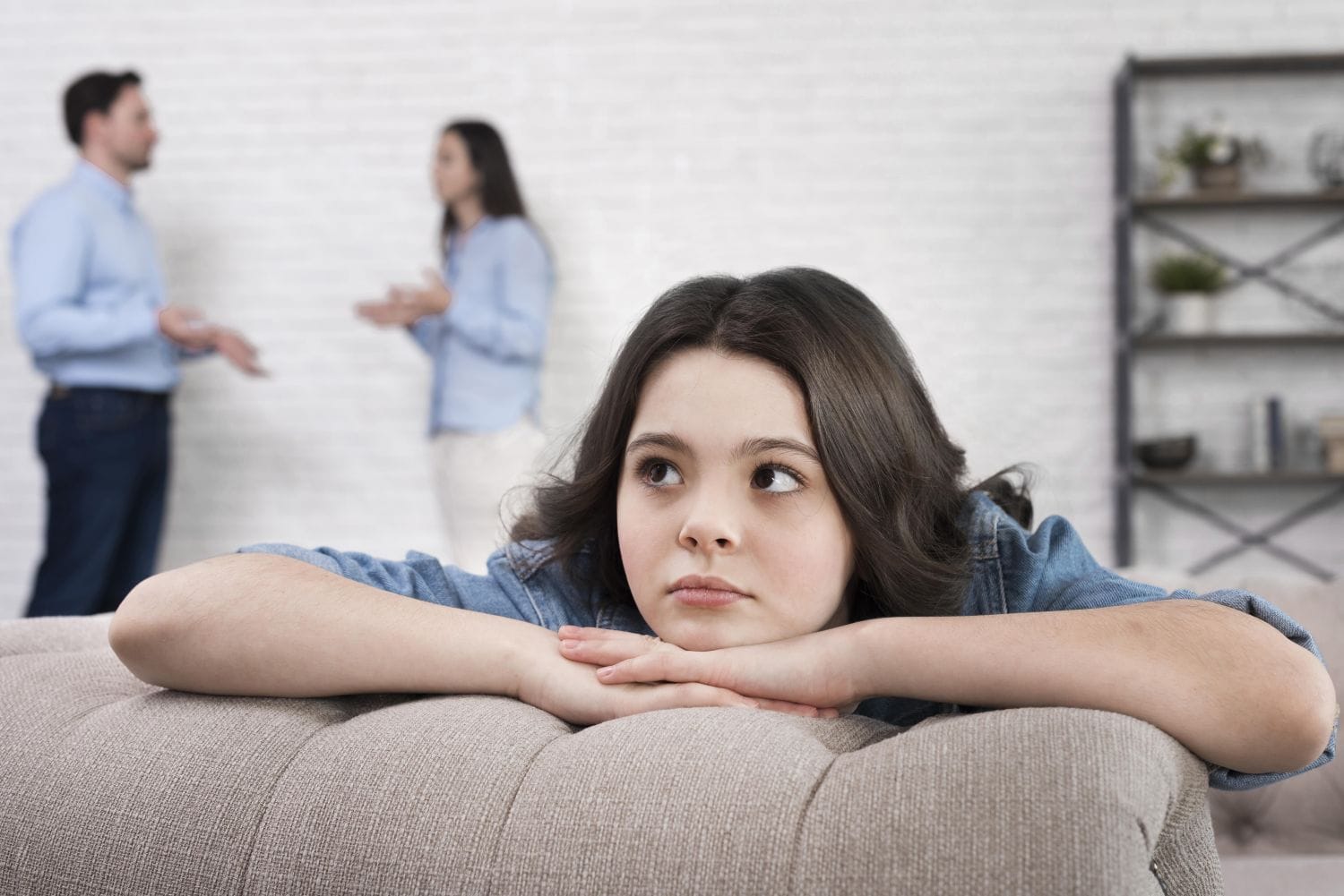 girl with parents arguing about divorce